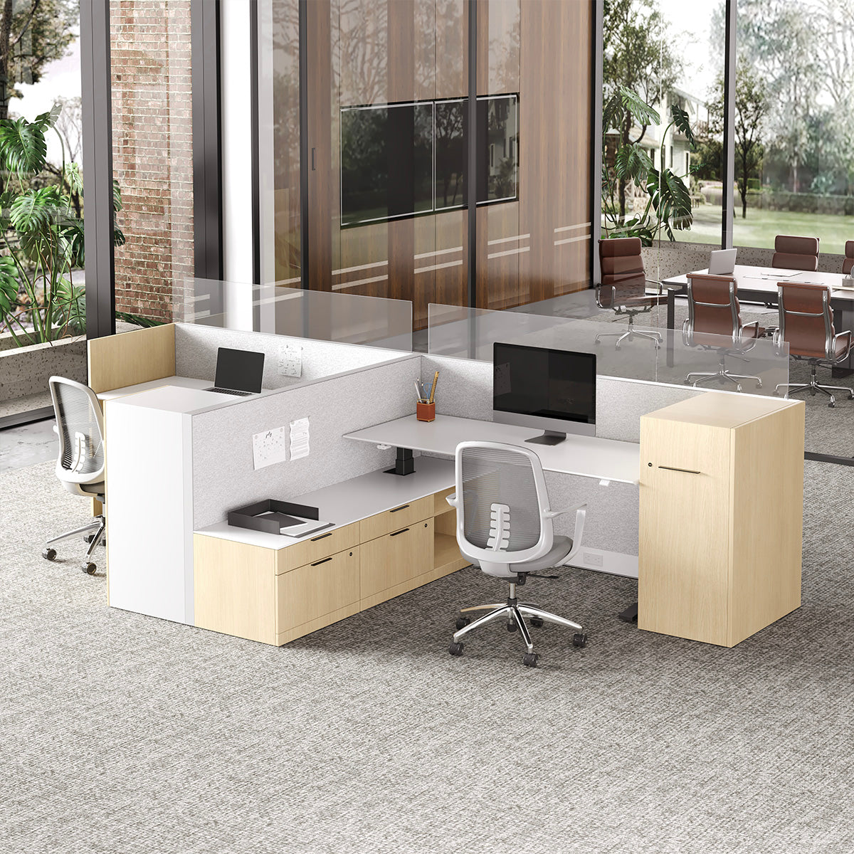 Modern office setup with desks, chairs, and a large window view.